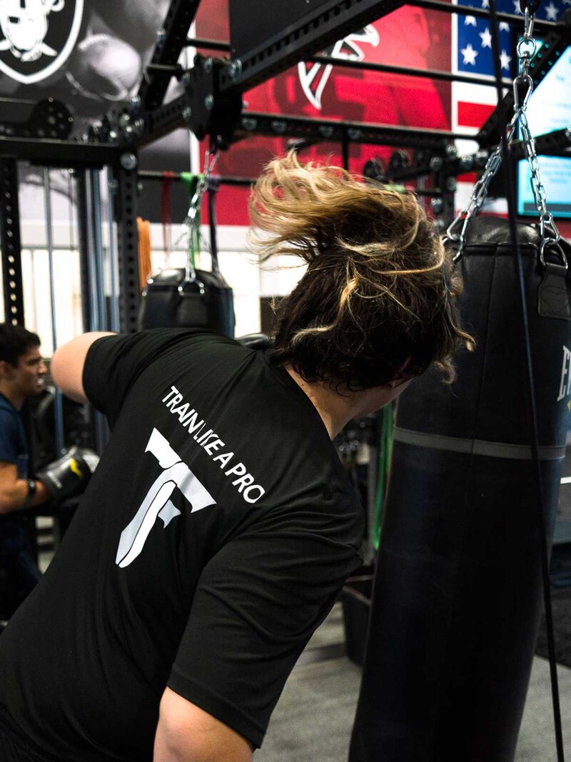 An adult athlete training with a slam ball